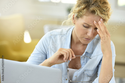 Woman at work suffering painful headache