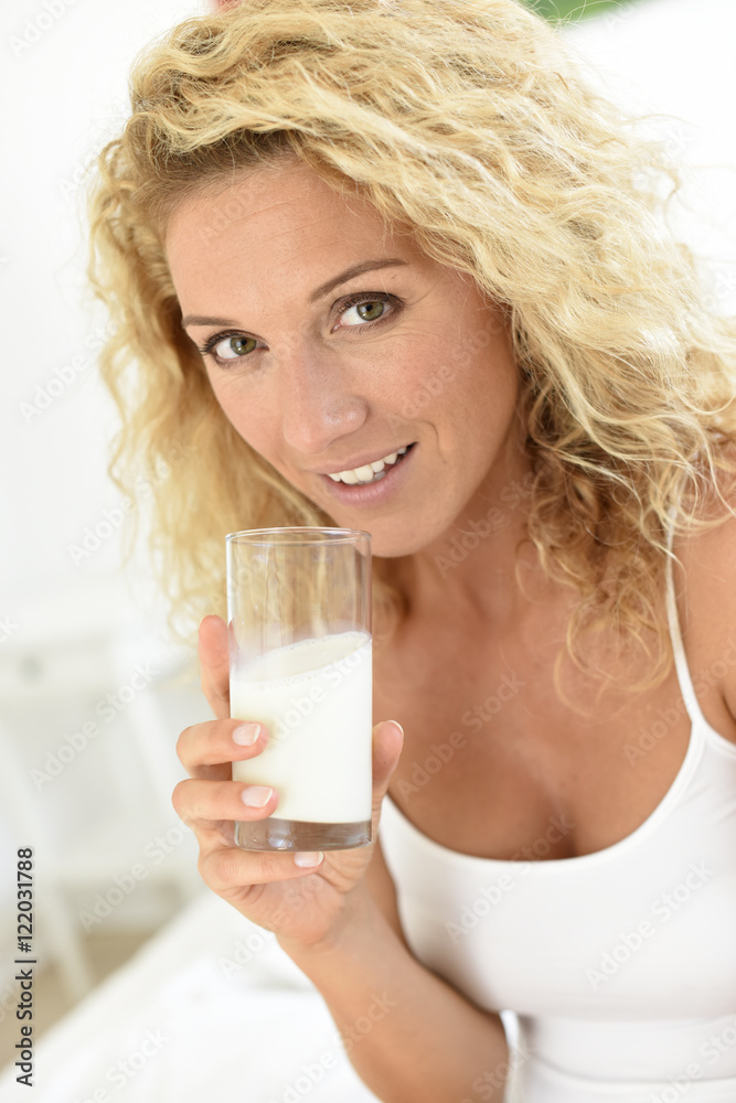 Middle-aged woman drinking milk in the morning Middle-aged woman drinking milk in the morning