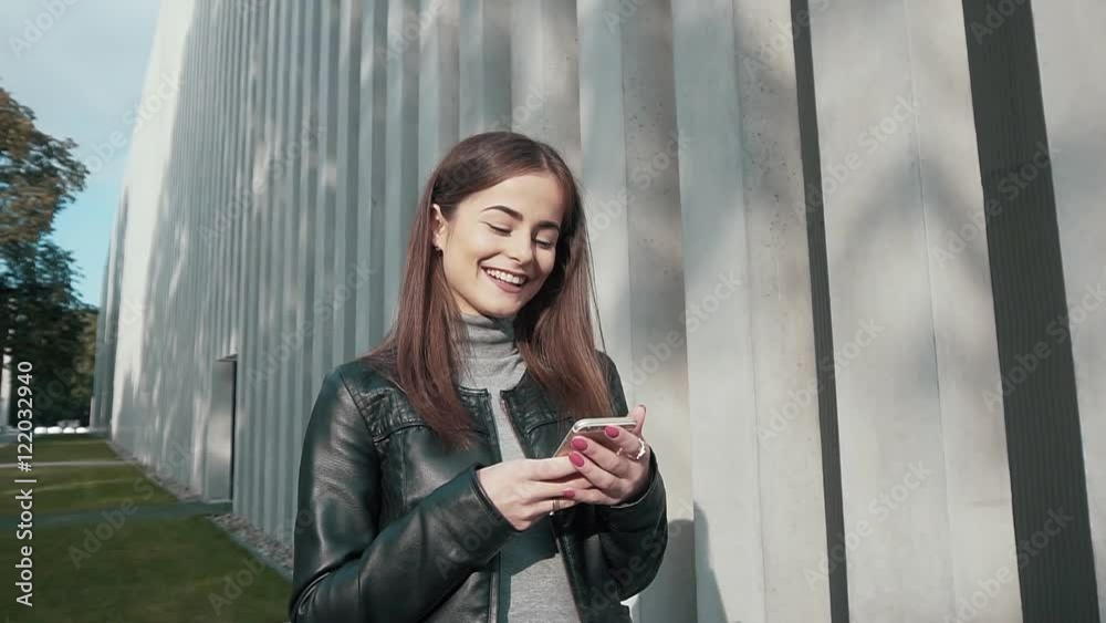 Woman using app on smartphone smiling and texting on mobile phone. Beautiful multicultural young casual female professional on mobile phone. Mixed race Caucasian Caucasian model. Woman using app on smartphone smiling and texting on mobile phone. Beautiful multicultural young casual female professional on mobile phone. Mixed race Caucasian Caucasian model.