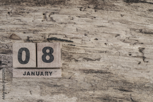 Cube calendar for january on wooden background with copy space