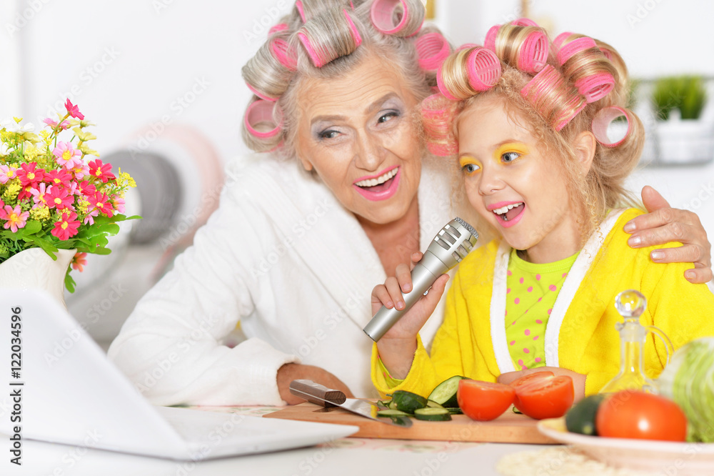 Senior woman and granddaughter at kitchen Senior woman and granddaughter at kitchen
