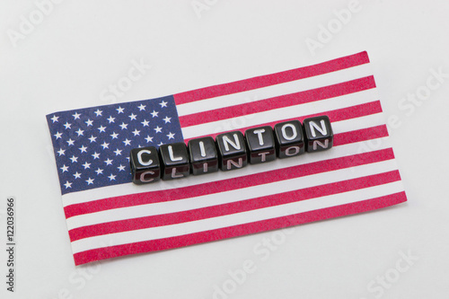 Clinton, on the background of the flag photo