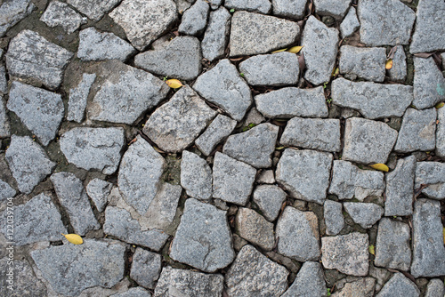 Cobble stone floor on sidewalk - texture background, focus on foreground.