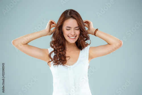 The happy woman on gray background