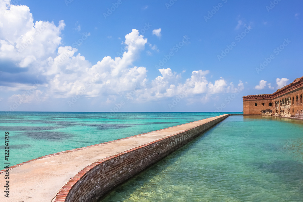 Northern Side of Fort Jefferson on Dry Tortugas National Park, Florida. Concrete Walkway around Fort Jefferson with the crystal clear waters of the Gulf of Mexico surround it.