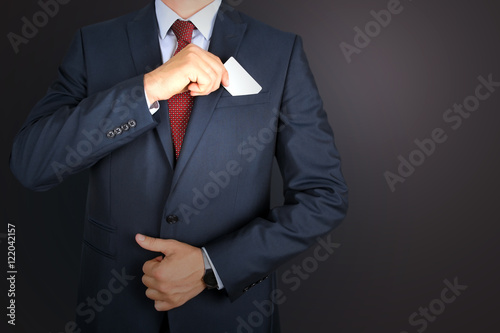 business man taking out business card from the pocket of busine