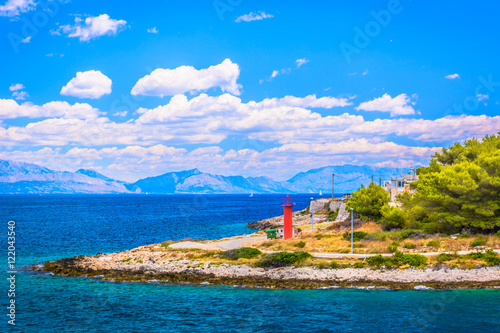 Croatia coast seascape. / Waterfront view at seascape in Croatia, marble Adriatic sea and lighthouse at island, Europe.