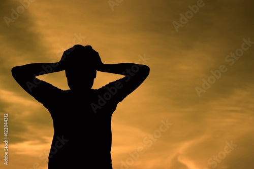 Silhouette of a Woman with Hands on Head