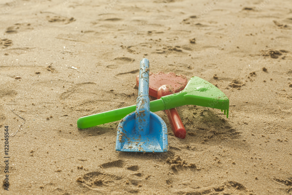 Summer beach colorful toys in the wet sand. Selective focus. Summer beach colorful toys in the wet sand. Selective focus.