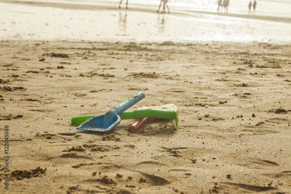 Summer beach colorful toys in the wet sand. Selective focus. Summer beach colorful toys in the wet sand. Selective focus.