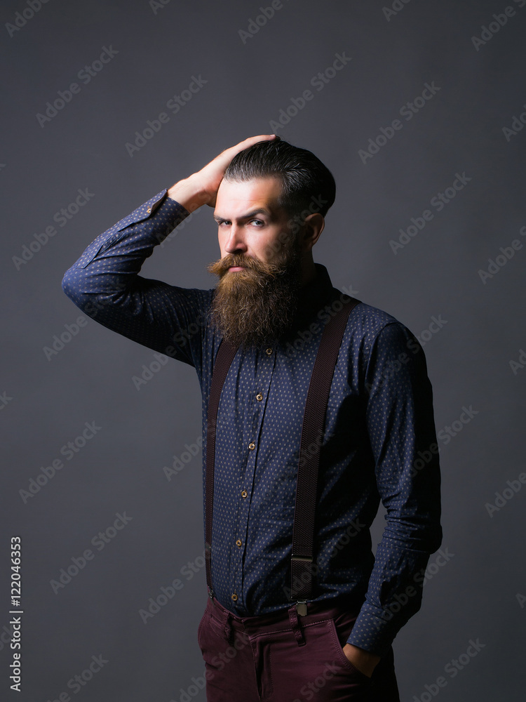Man hipster tidies hair