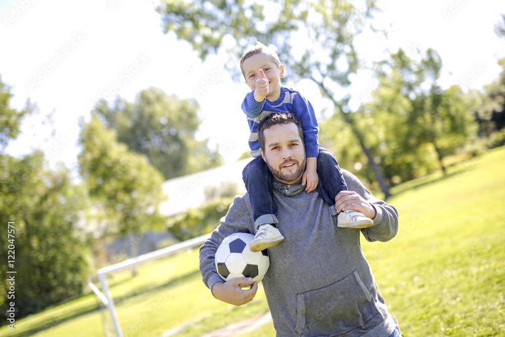 Father and Son Playing Ball in The Park