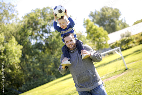 Father and Son Playing Ball in The Park photo