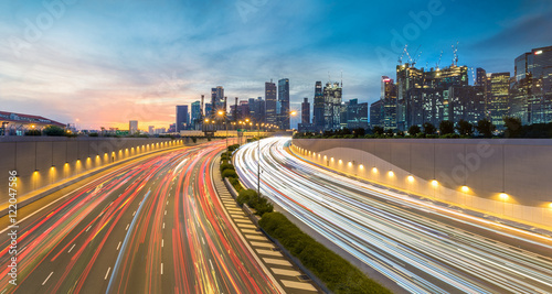 Movement of car light with Singapore cityscape skyline during sunset