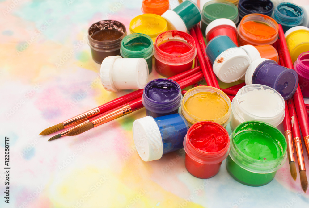 Paints, brushes and palette on the colorful background. The workplace of the artist. Banner for school Paints, brushes and palette on the colorful background. The workplace of the artist. Banner for school