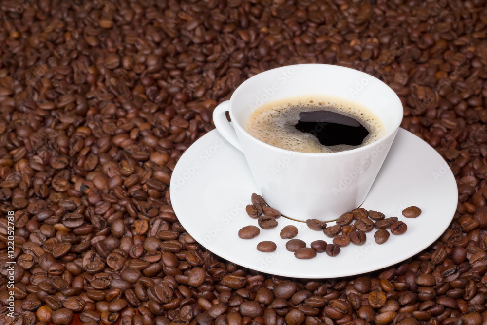 Cup of coffee over coffee beans Cup of coffee over coffee beans