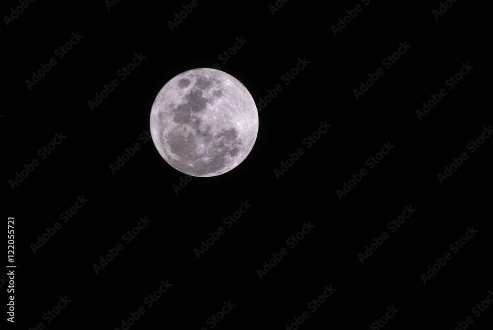 Full moon over dark black sky at night Full moon over dark black sky at night