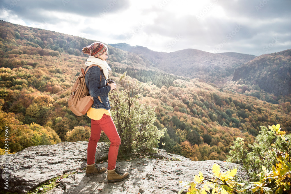 Beautiful woman with backpack against colorful sunny autumn fore Beautiful woman with backpack against colorful sunny autumn fore