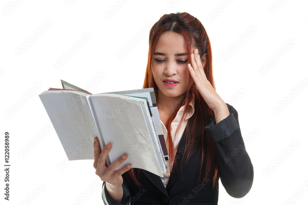 Young Asian business woman got headache read a book. Young Asian business woman got headache read a book.