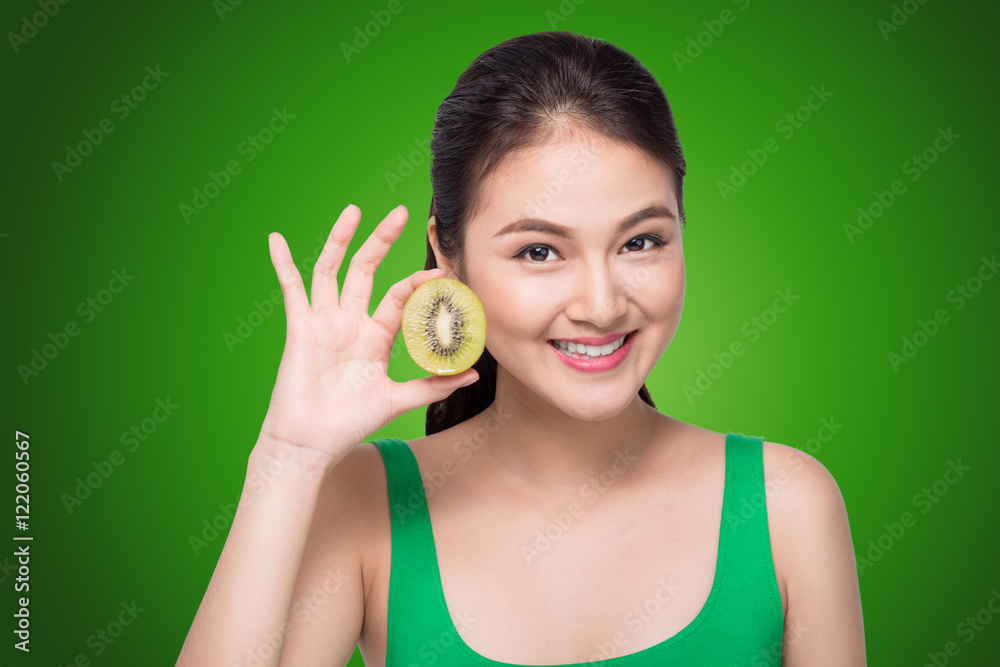 Portrait on young and healthy asian woman with kiwi fruit isolat Portrait on young and healthy asian woman with kiwi fruit isolat