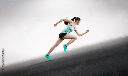 female runner sprinting up hill