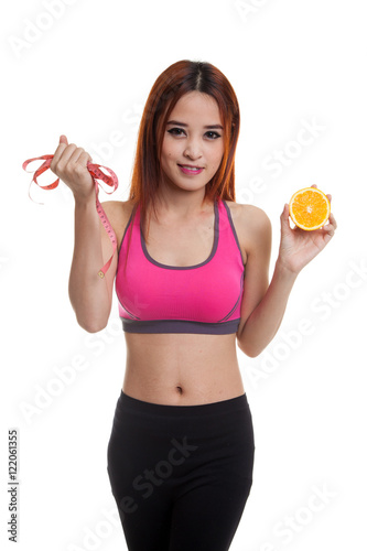 Asian healthy girl on diet with orange fruit and measuring tape.