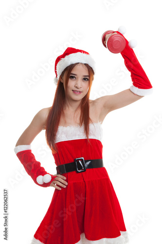 Asian Christmas girl with Santa Claus clothes and red dumbbell.