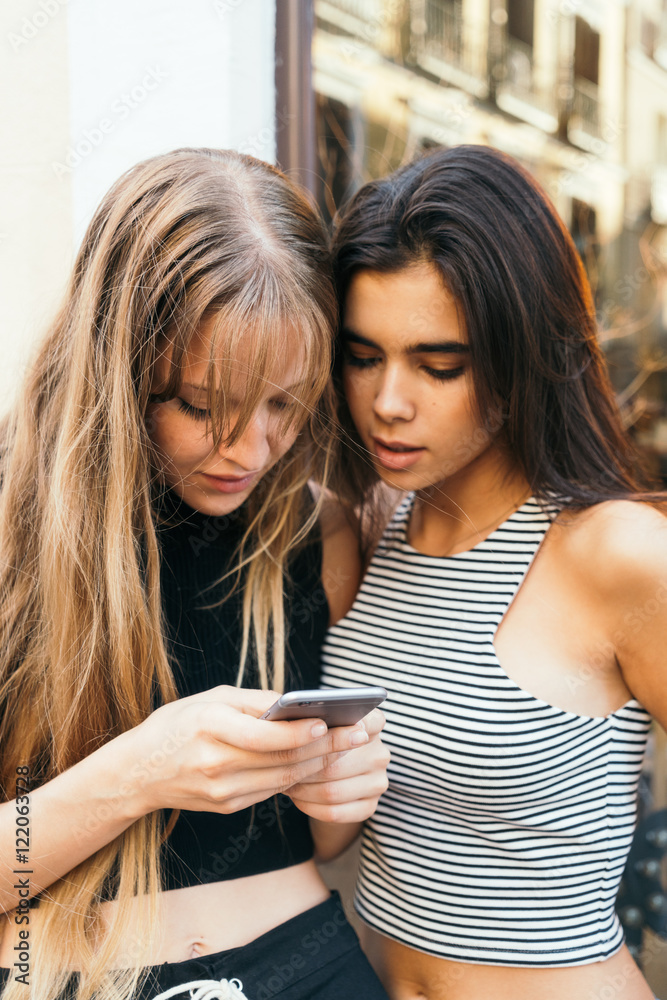 Two sexy girls using smartphone Two sexy girls using smartphone