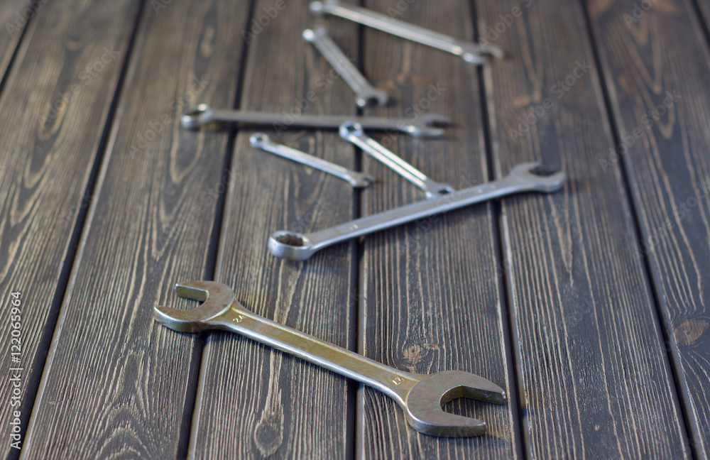 wrenches on wooden background wrenches on wooden background
