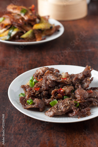 Spicy cumin lamb - traditional Uyghur dish from Xinjiang region in China. Twice cooked pork - traditional Chinese dish from Sichuan region 