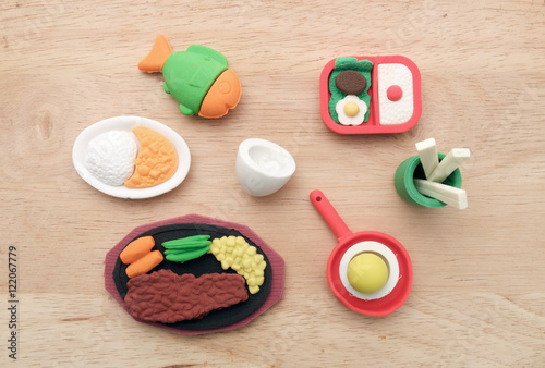 Toy food / View of miniature toy food on wood background. Top view. Flat lay.