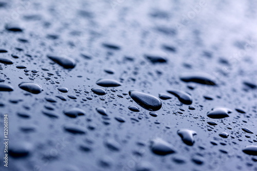 Close-up of Raindrops on Blue Metal
