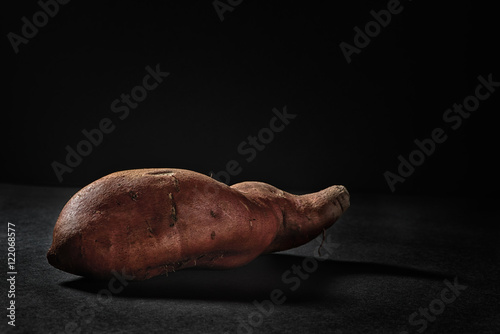 Sweet potato on black background