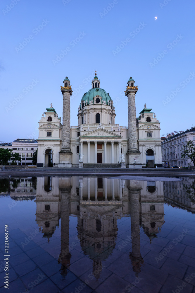 Karlskirche in Vienna Austria at sunset with reflection and shining moon in the purple sky, St Charles's church