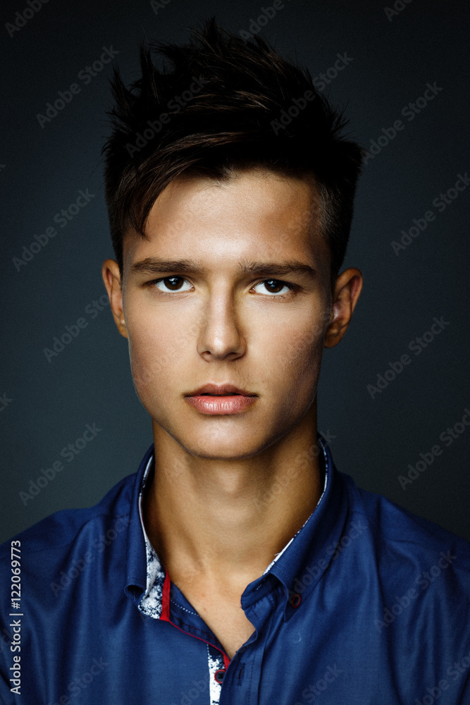 Obraz premium Handsome young man wearing shirt, portrait shot in studio