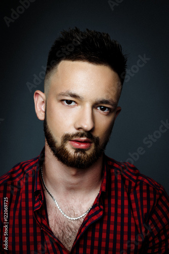 Handsome bearded man wearing shirt, portrait shot in studio