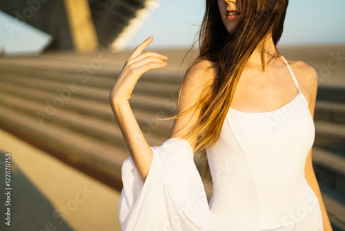Subtle ballerina in white dress in wind