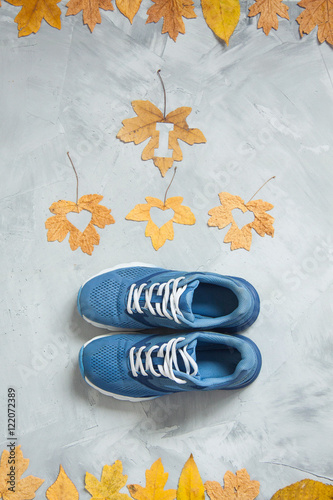 I love running composition with leaves and sport shoes on a conc