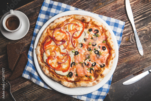 Delicious fresh pizza served on wooden table with coffee