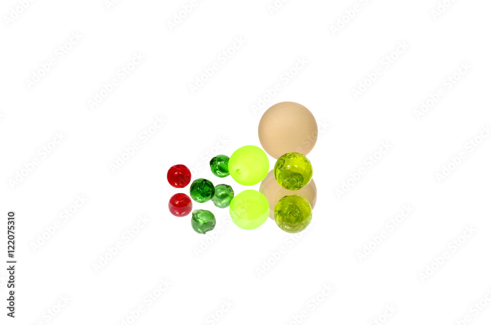 Glass beads of different size on white background - vignette