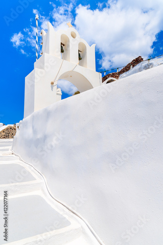 White church tower in Oia village on Santorini island, Greece