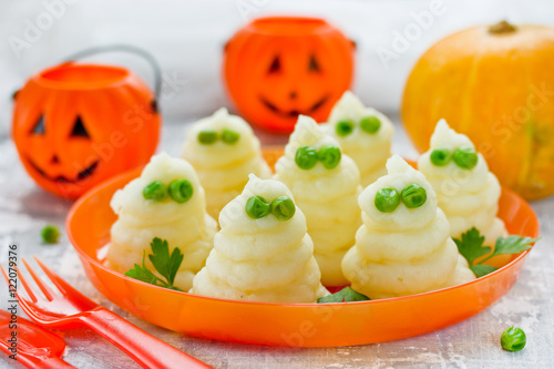 Mashed potatoes ghosts with green peas eyes, hot dinner dish