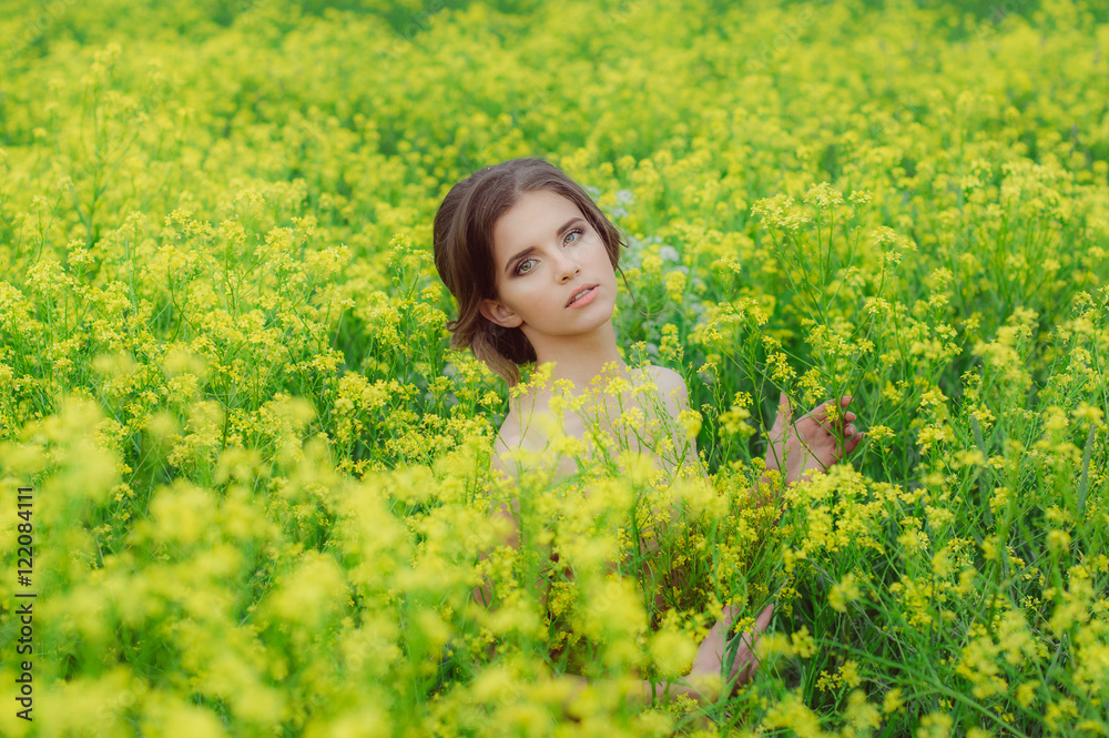 Portrait of young beautiful girl in field looking to the camera Portrait of young beautiful girl in field looking to the camera