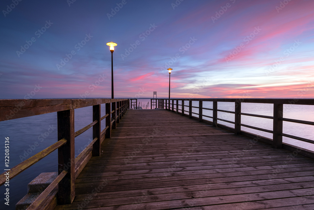 Obraz premium Small wooden pier at sunset time Port of Kuznica on Hel Peninsula. Poland. 