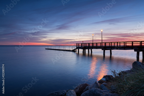 A view of wooden pier at sunset time. Port of Kuznica on Hel Peninsula. Poland. 