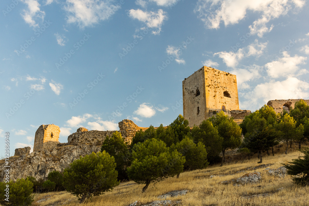Ruins of the fortress of Teba on top of the hill at sunset (Spain)