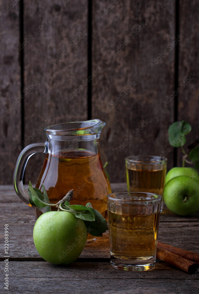 Glasses with apple juice on wooden table Glasses with apple juice on wooden table