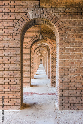 A series of brick arches inside Fort Jefferson. Fort Jefferson is a military historical fortress in the Dry Tortugas National Park, Florida. © bennymarty