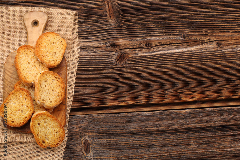 Grilled toasts on old wooden background and space for text Grilled toasts on old wooden background and space for text
