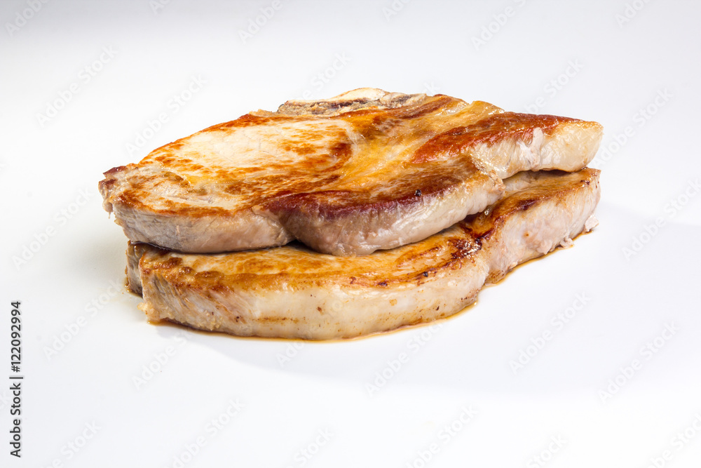 Two pieces of fried pork loin on a white background. Not isolate Two pieces of fried pork loin on a white background. Not isolate